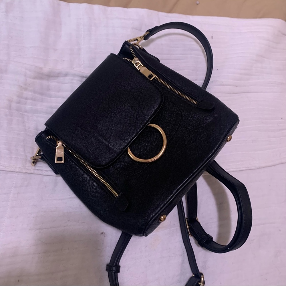 Small black and gold backpack